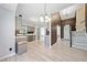Open concept kitchen and foyer with light wood floors and painted cabinets at 1131 Orr Rd, Jonesboro, GA 30238