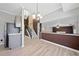 Open-concept living space with light wood floors, updated lighting, and a staircase leading to the upper level at 1131 Orr Rd, Jonesboro, GA 30238