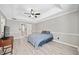 Open main bedroom boasts neutral walls with white trim, light wood-look floors, and tray ceiling with ceiling fan at 1131 Orr Rd, Jonesboro, GA 30238