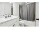 Modern bathroom with white vanity, bathtub, and grey shower curtain at 6829 Crescendo Ct, Atlanta, GA 30328