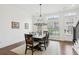 Bright dining room with hardwood floors, chandelier, and seating for six at 6829 Crescendo Ct, Atlanta, GA 30328