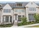Stunning townhome exterior featuring brick detailing and a charming front porch at 6829 Crescendo Ct, Atlanta, GA 30328