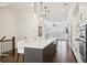 Open kitchen with white cabinets, stainless steel appliances, and an island at 6829 Crescendo Ct, Atlanta, GA 30328