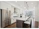 Modern kitchen boasts stainless steel appliances and a large island with seating at 6829 Crescendo Ct, Atlanta, GA 30328