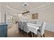 Formal dining room with hardwood floors, gray chairs, and decorative wallpaper at 920 Riverhaven Dr, Suwanee, GA 30024