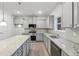 Modern kitchen with gray cabinets, granite countertops and stainless steel appliances at 1391 Stephens View Dr, Loganville, GA 30052