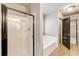 Well-lit bathroom featuring a modern shower and a luxurious soaking tub at 3236 Tallon Sw Ln, Atlanta, GA 30311