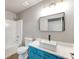 Vibrant bathroom with blue vanity, contemporary sink, and modern fixtures at 3236 Tallon Sw Ln, Atlanta, GA 30311