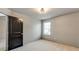 Cozy bedroom with plush carpeting, a window, and a gray accent wall for a modern touch at 3236 Tallon Sw Ln, Atlanta, GA 30311