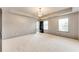 Spacious bedroom with neutral walls, carpet and a modern light fixture, offering a serene retreat at 3236 Tallon Sw Ln, Atlanta, GA 30311