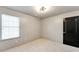 Neutral bedroom with a window bringing in light and a contemporary light fixture at 3236 Tallon Sw Ln, Atlanta, GA 30311