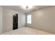 Cozy bedroom with plush carpeting, a window, and a gray accent wall for a modern touch at 3236 Tallon Sw Ln, Atlanta, GA 30311