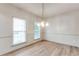 This dining room offers hardwood floors, light gray walls, and a modern lighting fixture at 3236 Tallon Sw Ln, Atlanta, GA 30311