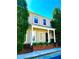 Charming two-story home featuring a welcoming front porch with white columns and well-maintained landscaping at 3236 Tallon Sw Ln, Atlanta, GA 30311