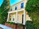 Charming two-story home featuring a welcoming front porch with white columns and well-maintained landscaping at 3236 Tallon Sw Ln, Atlanta, GA 30311