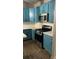 Updated kitchen features custom blue cabinets, stainless steel appliances, and sleek countertops at 3236 Tallon Sw Ln, Atlanta, GA 30311