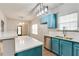 Stylish kitchen with blue cabinets, quartz countertops, stainless steel sink, and modern lighting at 3236 Tallon Sw Ln, Atlanta, GA 30311