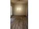 Bright living room featuring hardwood floors and a modern light fixture at 3236 Tallon Sw Ln, Atlanta, GA 30311