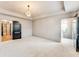Main bedroom with neutral carpet, tray ceiling, and a doorway to the bathroom and closet at 3236 Tallon Sw Ln, Atlanta, GA 30311