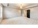 Large main bedroom featuring plush carpeting, tray ceiling, and an ensuite bathroom at 3236 Tallon Sw Ln, Atlanta, GA 30311