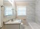 Clean bathroom, featuring granite countertop, marble tile, and a bathtub at 3235 Mcafee Rd, Decatur, GA 30032
