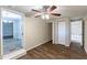 Bedroom with ceiling fan, wood-look floors and access to other rooms at 3235 Mcafee Rd, Decatur, GA 30032