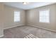 Bright bedroom with neutral walls and carpet, featuring two windows with blinds at 3235 Mcafee Rd, Decatur, GA 30032