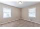 Well-lit bedroom with neutral walls and carpet flooring, offering two windows at 3235 Mcafee Rd, Decatur, GA 30032