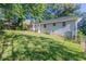 Back of house with large yard and mature trees at 3235 Mcafee Rd, Decatur, GA 30032