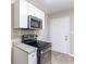 Updated kitchen with stainless steel appliances and white cabinets at 3235 Mcafee Rd, Decatur, GA 30032