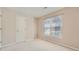 Well-lit bedroom with window, neutral walls, and carpet flooring at 3314 Mill Grove Ter, Dacula, GA 30019
