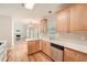 Bright kitchen with wood cabinets, stainless steel appliances, and hardwood floors at 3314 Mill Grove Ter, Dacula, GA 30019