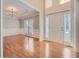Bright living room with hardwood floors and a view to the foyer at 3314 Mill Grove Ter, Dacula, GA 30019