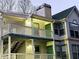Building exterior showcasing a three-story townhome with balconies and green accents at 3526 Shepherds Path # 1, Decatur, GA 30034