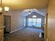 Open living space with vaulted ceilings, carpeting, and access to a patio at 3526 Shepherds Path # 1, Decatur, GA 30034