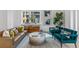 Spacious living room with leather sofa and teal armchairs at 775 Juniper Ne St # 103, Atlanta, GA 30308