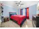 Bedroom with a ceiling fan, blue walls, carpet flooring and a bed with red bedding at 1947 Greensferry Gln, Lawrenceville, GA 30043