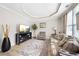 Cozy living room with wood floors, a comfortable sofa, and neutral decor at 1947 Greensferry Gln, Lawrenceville, GA 30043