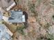 An aerial view shows the home's roof, landscaping, and proximity to neighboring houses and tree coverage at 3730 Ashford Ne Pt, Brookhaven, GA 30319