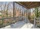 This outdoor back deck area features painted railings, natural views, and stairs leading down to the backyard at 3730 Ashford Ne Pt, Brookhaven, GA 30319