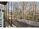 This backyard has a natural slope into the woods and is accessible by stairs leading down from the deck at 3730 Ashford Ne Pt, Brookhaven, GA 30319