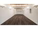 Finished basement with wood floors, decorative beams, and stylish sconce lighting at 3730 Ashford Ne Pt, Brookhaven, GA 30319