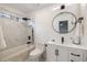 Modern bathroom with white marble, black fixtures, vanity, and a shower-tub combo at 3730 Ashford Ne Pt, Brookhaven, GA 30319