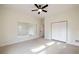 An airy bedroom features plush carpet, a large mirror, and a closet with double doors, providing ample storage at 3730 Ashford Ne Pt, Brookhaven, GA 30319