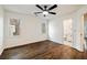 Bright bedroom with hardwood floors and two windows leading to an ensuite bath at 3730 Ashford Ne Pt, Brookhaven, GA 30319