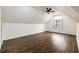 Spacious room with ceiling fan and window, highlighting the ample space and hardwood floors at 3730 Ashford Ne Pt, Brookhaven, GA 30319