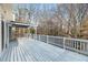 Expansive outdoor deck featuring a pergola, railing, and scenic wooded views at 3730 Ashford Ne Pt, Brookhaven, GA 30319