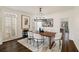 Elegant dining room with hardwood floors, modern lighting, and stylish decor providing a sophisticated and inviting space for meals at 3730 Ashford Ne Pt, Brookhaven, GA 30319