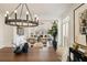 Elegant dining room showcasing stylish lighting, wood table, and views into the living room at 3730 Ashford Ne Pt, Brookhaven, GA 30319