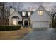 Charming two-story home with a well-manicured lawn, a two-car garage, and elegant black front door at 3730 Ashford Ne Pt, Brookhaven, GA 30319